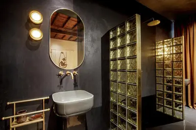 a bathroom with a sink and a mirror at Daplace - Palazzo Serpe Suites near Colosseum in Rome
