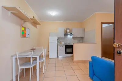 a kitchen and dining room with a table and chairs at Casa Roma - La Casetta di Vale in Rome