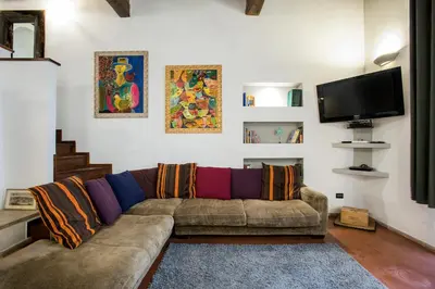 a living room with a couch and a flat screen tv at Charming Pantheon Apt in the heart of Rome in Rome