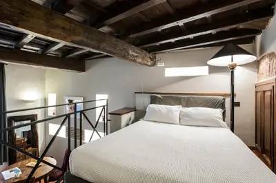 a bedroom with a bed in a room with wooden ceilings at Charming Pantheon Apt in the heart of Rome in Rome