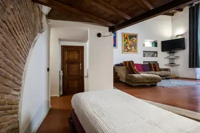 a bedroom with a bed and a living room at Charming Pantheon Apt in the heart of Rome in Rome