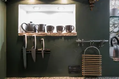 a kitchen with knives and utensils on a wall at Charming Pantheon Apt in the heart of Rome in Rome