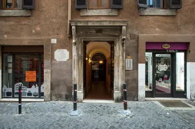 a building with a door in the middle of a street at Charming Pantheon Apt in the heart of Rome in Rome