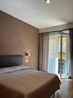 a bedroom with a bed and a sliding glass door at Eva suite in Rome