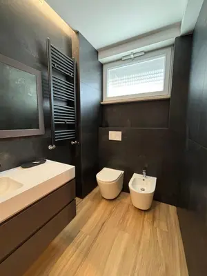 a bathroom with a sink and a toilet and a window at Eva suite in Rome