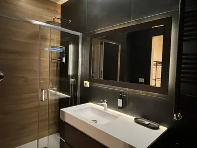 a bathroom with a sink and a mirror at Eva suite in Rome