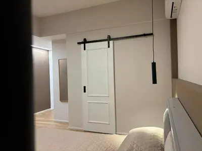 a white sliding door in a room with a bed at Eva suite in Rome