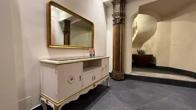 a bathroom with a dresser with a mirror on it at Santonofrio Apartments Silver e White in Rome