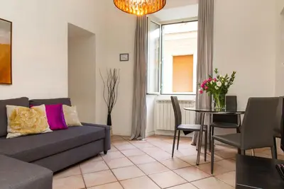 a living room with a couch and a table at Santonofrio Apartments Silver e White in Rome
