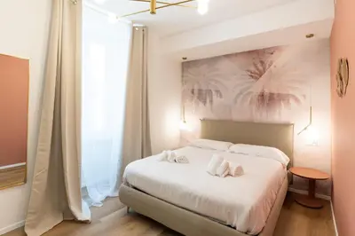 a bathroom with a bed and a tub and a television at Maison Rasella Suites in Rome