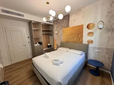 a bathroom with a bath tub on a marble wall at Maison Rasella Suites in Rome