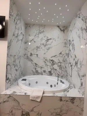 a bathroom with a toilet and a sink and a mirror at Maison Rasella Suites in Rome