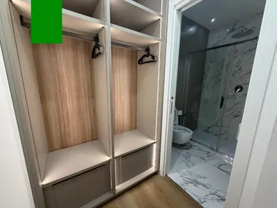 a room with a tv on a wall with a desk at Maison Rasella Suites in Rome