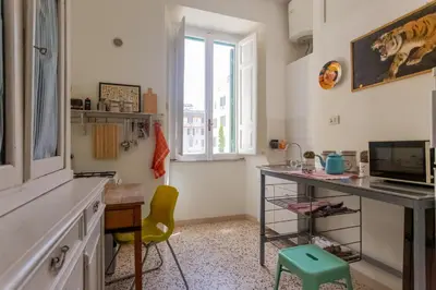 a kitchen with a desk and a chair in a room at Vintage Vibes in Testaccio - Cale 07 in Rome