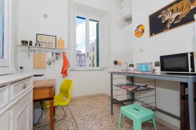 a kitchen with a desk and a table and a chair at Vintage Vibes in Testaccio - Cale 07 in Rome