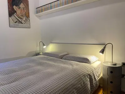 a bedroom with a bed with two lamps on it at Bollo flat in Rome