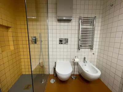 a bathroom with a toilet and a sink at Bollo flat in Rome