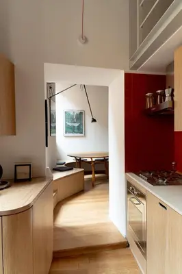 a kitchen with red and white walls and a table at Bollo flat in Rome