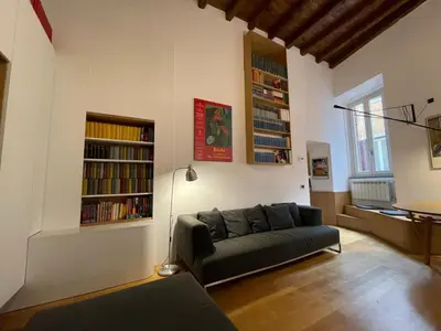 a living room with a couch and bookshelves at Bollo flat in Rome