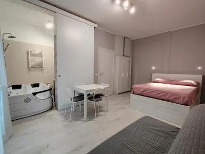 a bedroom with a bed and a sink and a table at Sweet Home in Rome