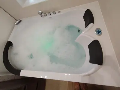 a bath tub filled with water in a bathroom at Sweet Home in Rome