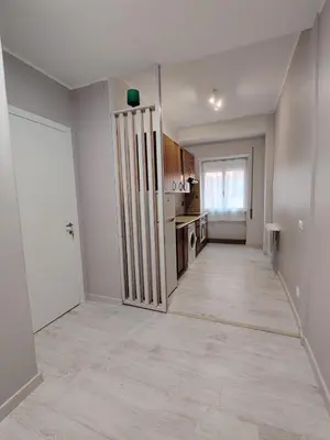 an empty living room with a kitchen and a hallway at Sweet Home in Rome
