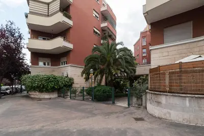 a building with a fence in front of it at GuestHost - Charming Apartment Metro Cipro in Rome