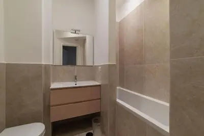 a bathroom with a sink and a toilet and a mirror at GuestHost - Charming Apartment Metro Cipro in Rome