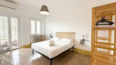 a bedroom with a bed with a teddy bear on it at Stylish Apt Balcony, AC,Aqueduct View in Rome