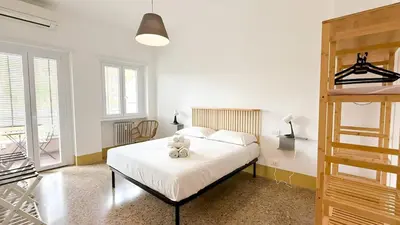 a bedroom with a bed with a teddy bear on it at Stylish Apt Balcony, AC,Aqueduct View in Rome