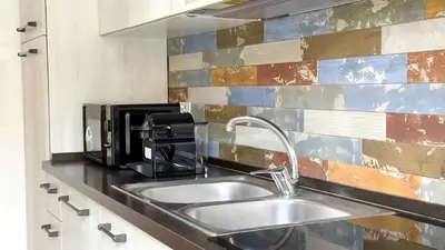 a kitchen with a sink and a coffee maker at Stylish Apt Balcony, AC,Aqueduct View in Rome