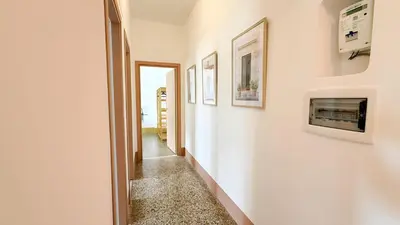 a hallway with white walls and a fireplace at Stylish Apt Balcony, AC,Aqueduct View in Rome
