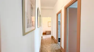 a hallway with a painting on the wall and a picture on the wall at Stylish Apt Balcony, AC,Aqueduct View in Rome