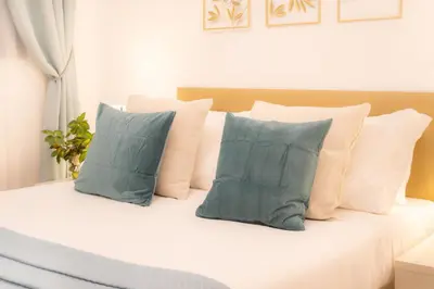 a group of pillows sitting on top of a bed at La Veranda dei Farnesi in Rome