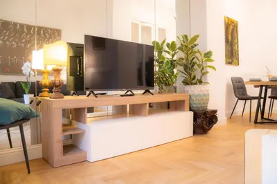 a living room with a television on a table at La Veranda dei Farnesi in Rome
