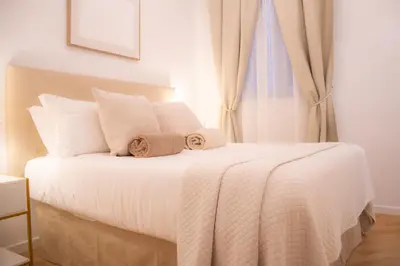 a bedroom with a white bed with towels on it at La Veranda dei Farnesi in Rome