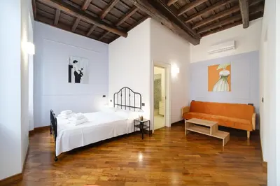 a bedroom with a bed and a couch at Dadada by BuddyRent in Rome