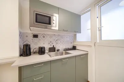 a kitchen with a sink and a microwave at Dadada by BuddyRent in Rome