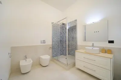 a bathroom with a shower and a toilet and a sink at Dadada by BuddyRent in Rome