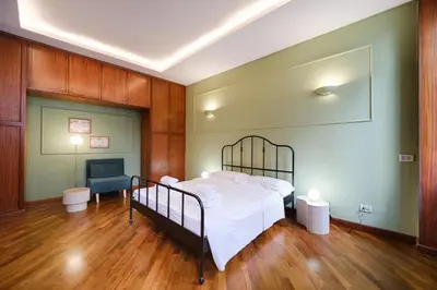 a bedroom with a bed in a room with wooden floors at Dadada by BuddyRent in Rome