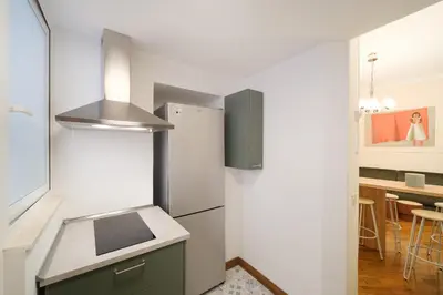 a kitchen with a refrigerator and a counter top at Dadada by BuddyRent in Rome