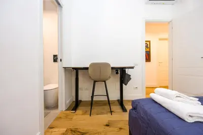 a room with a desk and a chair next to a bed at Paruta Rooms 22 in Rome