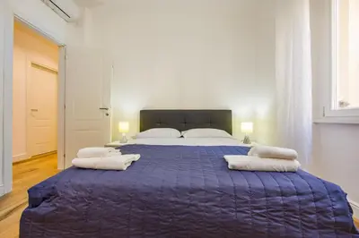 a bedroom with a large bed with towels on it at Paruta Rooms 22 in Rome