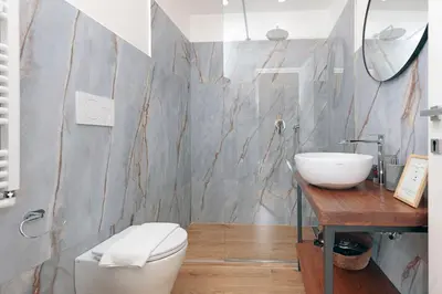 a bathroom with a white toilet and a sink at Malva Suite in Rome