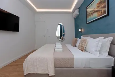 a bedroom with a large bed and a mirror at Malva Suite in Rome