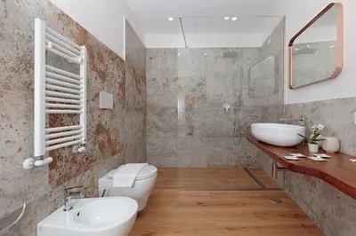 a bathroom with a sink and a toilet and a mirror at Malva Suite in Rome