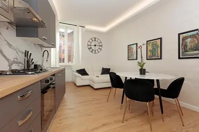 a kitchen and living room with a table and chairs at Malva Suite in Rome