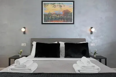 a bedroom with a bed with towels on it at Malva Suite in Rome
