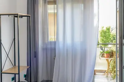 a room with a window with a white curtain at Vacanze Romane in Rome