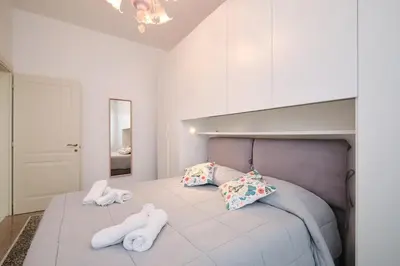 a bedroom with a bed with two white towels on it at Residenza Lucis - Camillo Hospital - Monteverde by Hôtea in Rome